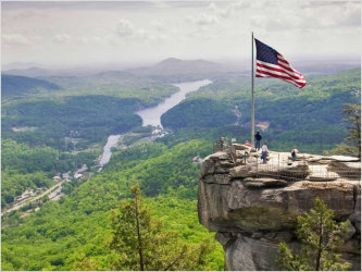 People standing on top of Chimney Rock looking over the valley