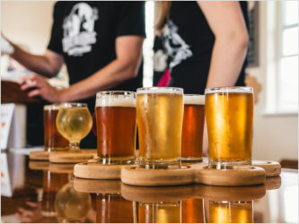 A barista serves a beer tasting flight